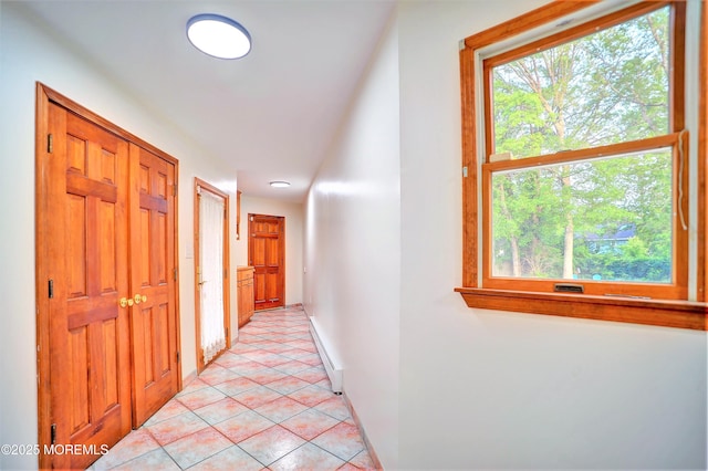 705 Princeton Rd, Lanoka Harbor, NJ 08734 - hallway featuring healthy amount of natural light, light tile patterned floors, a baseboard heating unit, and baseboards