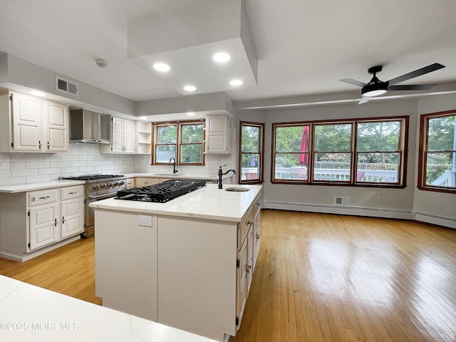 705 Princeton Rd, Lanoka Harbor, NJ 08734 - kitchen with wall chimney exhaust hood, black gas stovetop, white cabinets, light wood-style flooring, and recessed lighting