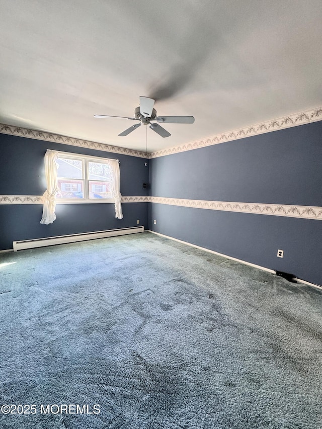 empty room featuring baseboard heating, ceiling fan, and carpet floors