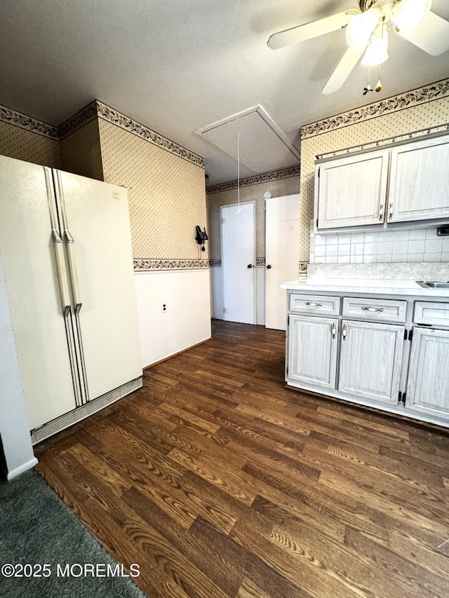 kitchen featuring white refrigerator, white cabinetry, dark hardwood / wood-style flooring, and ceiling fan