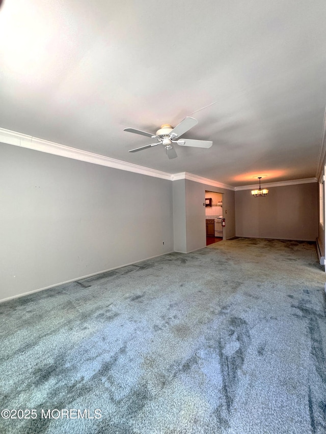 empty room with crown molding, ceiling fan with notable chandelier, and carpet