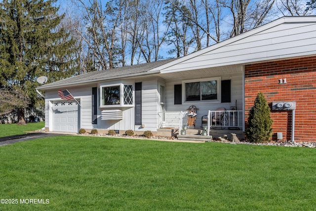 single story home featuring a garage, a porch, and a front lawn