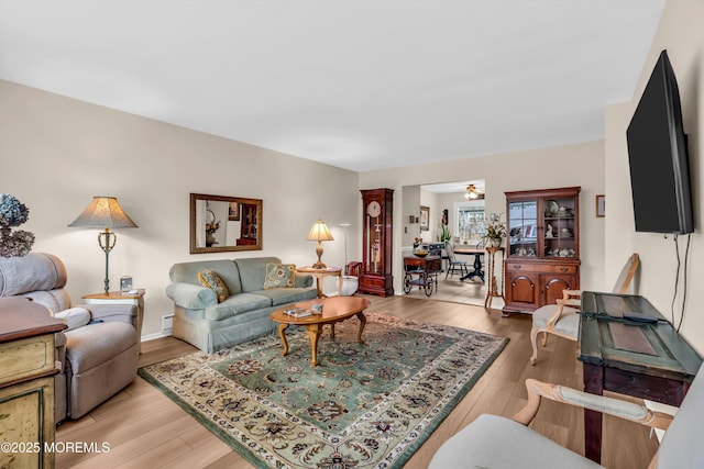 living room featuring ceiling fan and light wood-type flooring