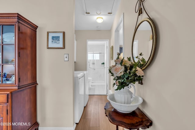 interior space featuring washer and dryer and light hardwood / wood-style flooring