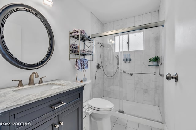 bathroom featuring vanity, toilet, tile patterned floors, and walk in shower