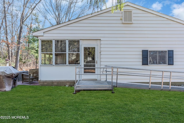 rear view of house with a yard