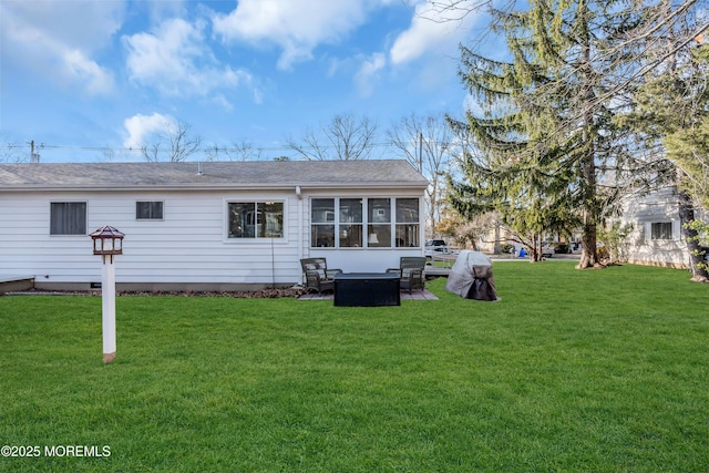 back of property featuring a sunroom and a yard