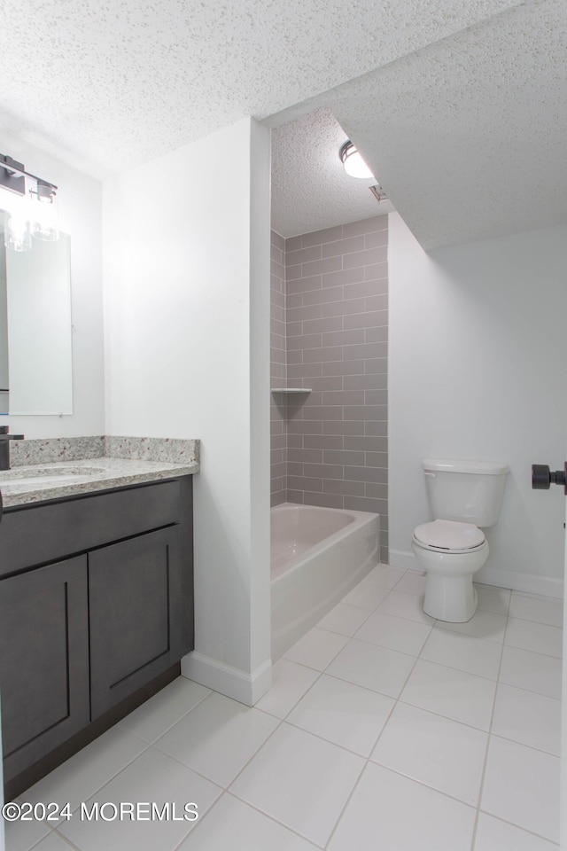 full bathroom with vanity, tiled shower / bath combo, tile patterned floors, and toilet