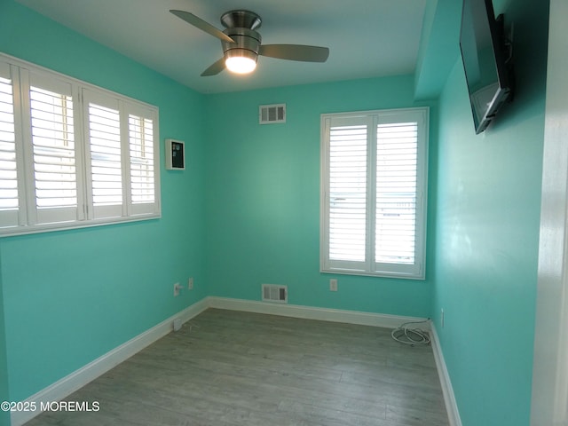 unfurnished room with ceiling fan and light wood-type flooring