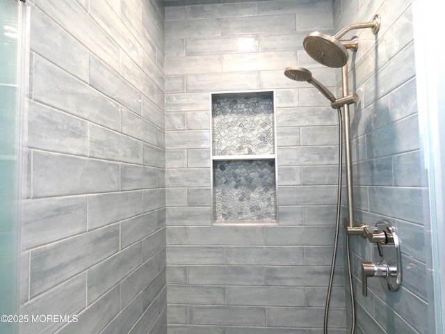 bathroom with tiled shower