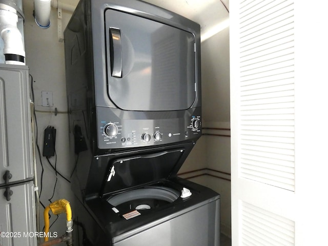 washroom with stacked washer / drying machine