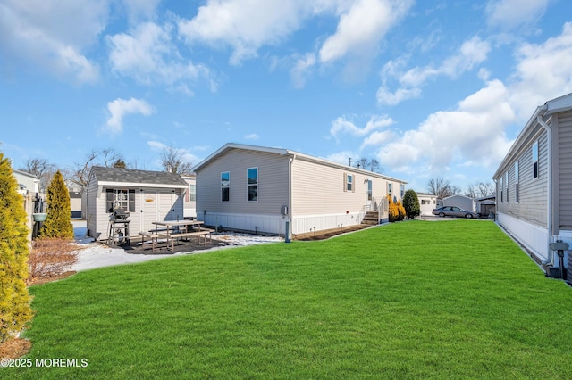 back of property with an outbuilding and a lawn