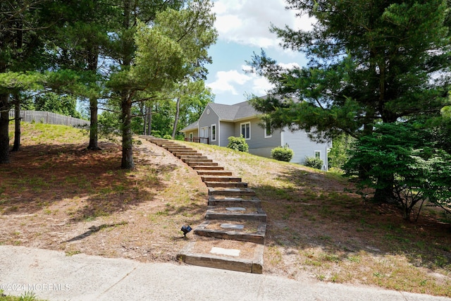 exterior space featuring fence and stairway