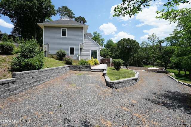 back of house with a lawn