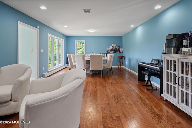 dining space featuring recessed lighting, visible vents, a baseboard heating unit, wood finished floors, and baseboards