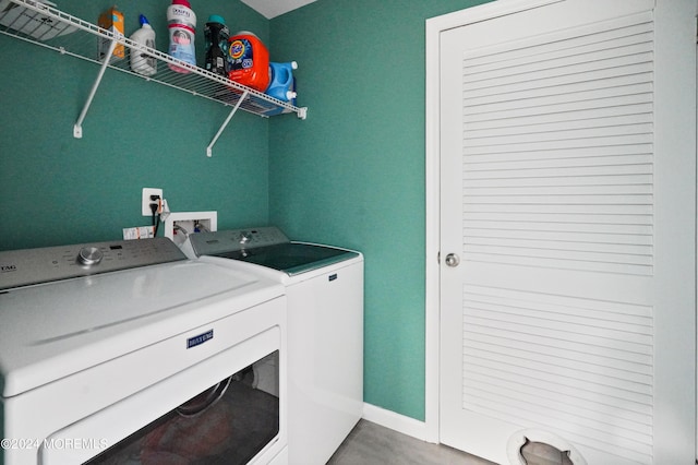 laundry area featuring laundry area, baseboards, and washer and dryer