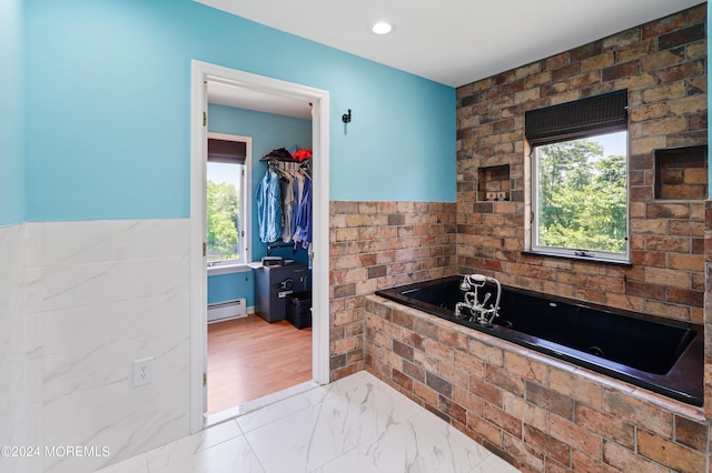 full bathroom featuring marble finish floor, a wainscoted wall, a baseboard radiator, recessed lighting, and a whirlpool tub