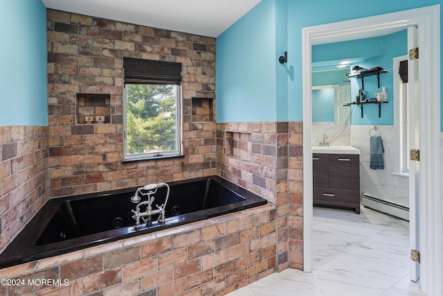 bathroom with marble finish floor, a wainscoted wall, a baseboard heating unit, vanity, and a jetted tub