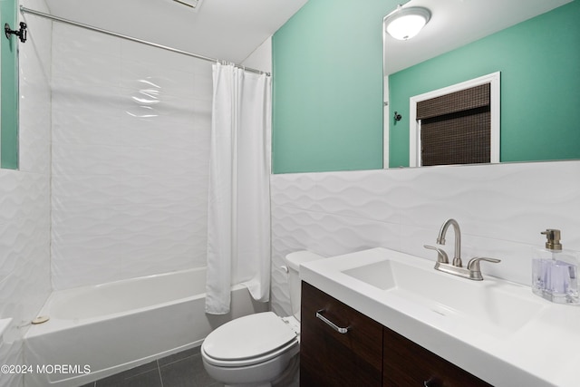 bathroom with toilet, vanity, tile walls, tile patterned floors, and shower / tub combo with curtain