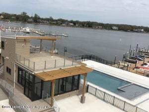 dock area with a patio and a water view