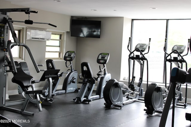 gym with expansive windows and a wall unit AC