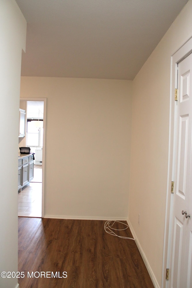 hallway with dark wood-type flooring