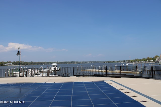 view of swimming pool featuring a water view