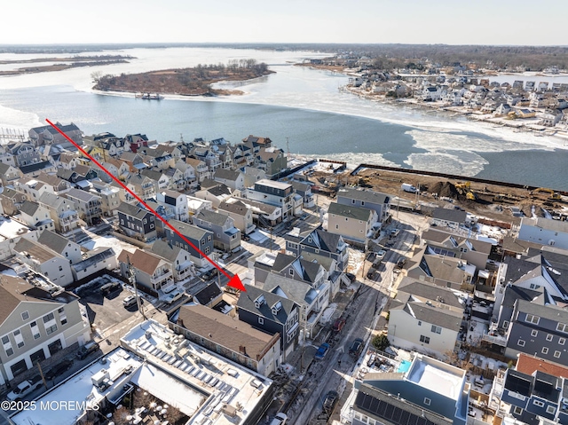 drone / aerial view with a water view and a residential view