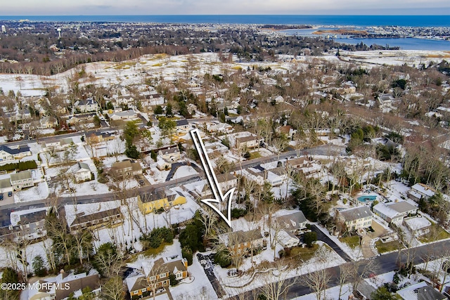 snowy aerial view featuring a water view