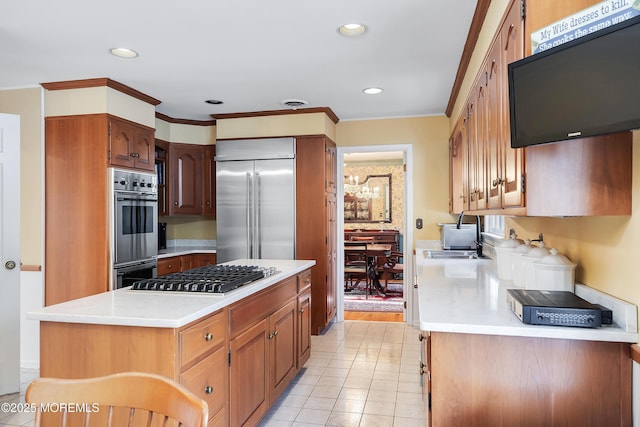 kitchen featuring stainless steel appliances, ornamental molding, sink, and light tile patterned floors