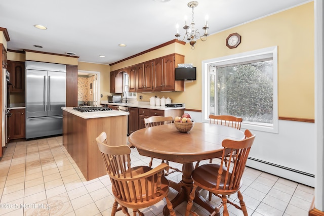 kitchen featuring pendant lighting, light tile patterned floors, baseboard heating, stainless steel appliances, and a center island