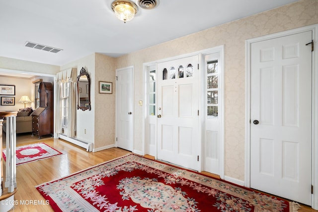 entrance foyer featuring hardwood / wood-style flooring and baseboard heating