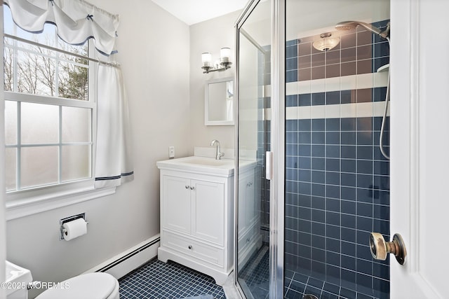 bathroom with toilet, a shower with shower door, a baseboard radiator, vanity, and tile patterned flooring