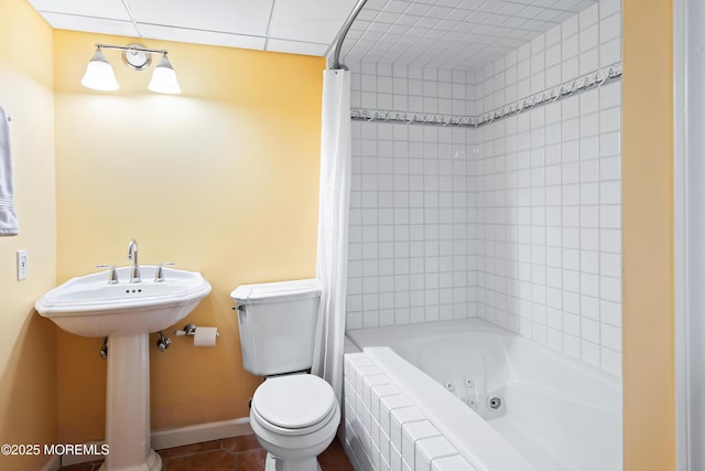 bathroom featuring shower / tub combo with curtain, tile patterned floors, and toilet