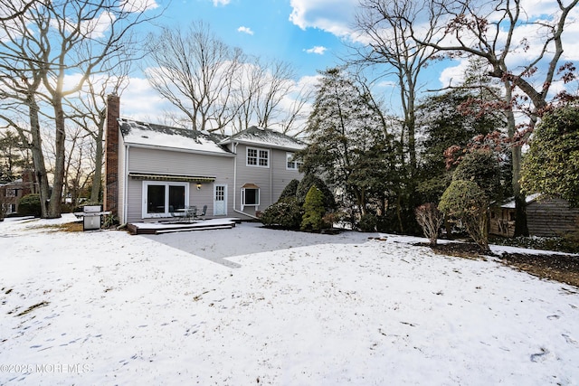 snow covered property featuring a deck