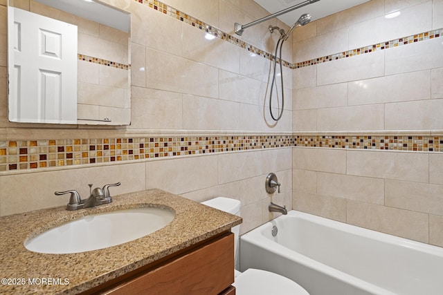 full bathroom featuring shower / bath combination, vanity, toilet, and tile walls