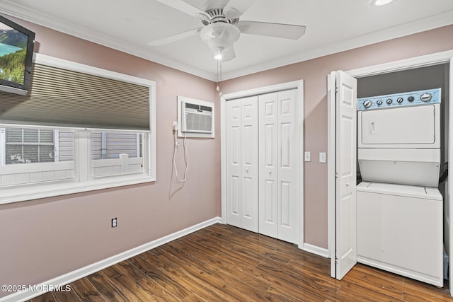 interior space featuring baseboards, stacked washer / dryer, dark wood-style flooring, crown molding, and an AC wall unit