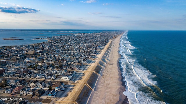 birds eye view of property featuring a view of the beach and a water view