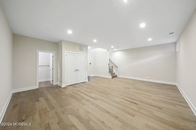 basement with light hardwood / wood-style floors