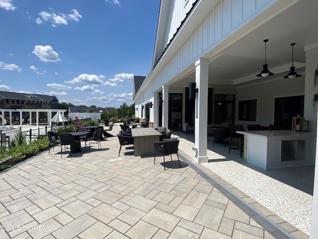 view of patio featuring ceiling fan and an outdoor bar