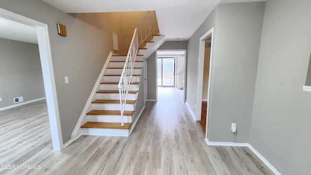 stairs featuring wood-type flooring