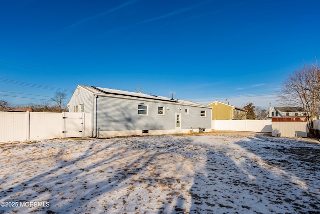 view of snow covered back of property