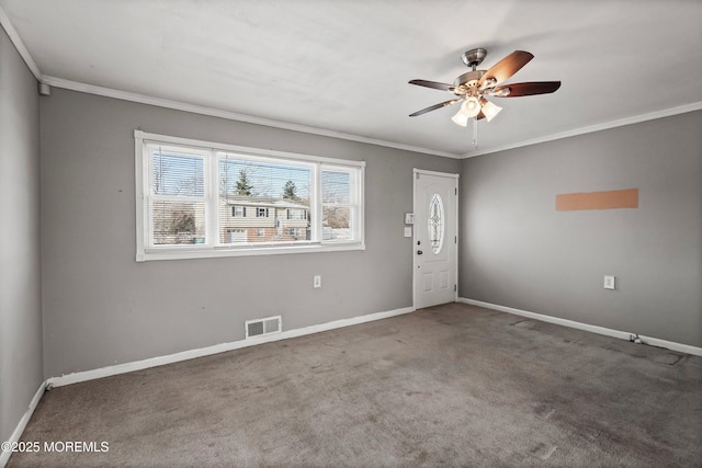 carpeted spare room with ornamental molding and ceiling fan