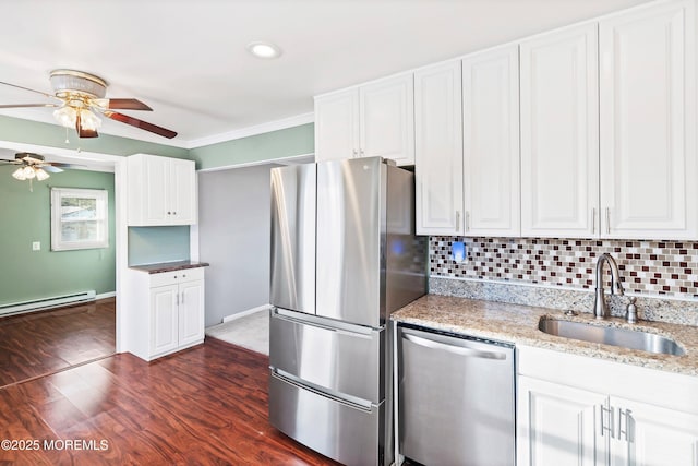 kitchen featuring sink, stainless steel appliances, light stone countertops, white cabinets, and a baseboard radiator