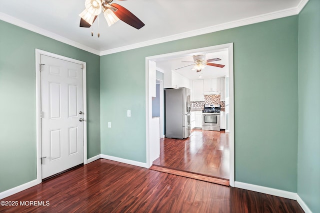 empty room featuring crown molding, dark hardwood / wood-style floors, and ceiling fan