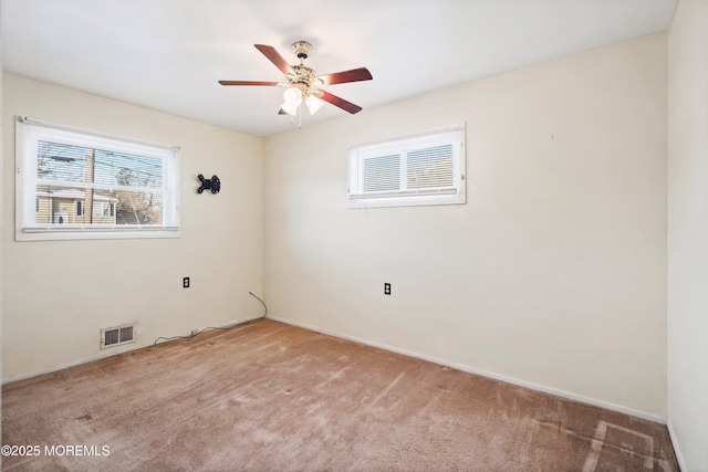 carpeted spare room with ceiling fan