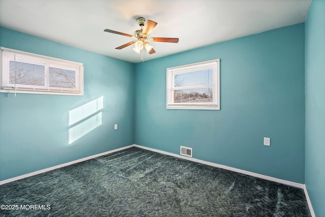 carpeted spare room with ceiling fan