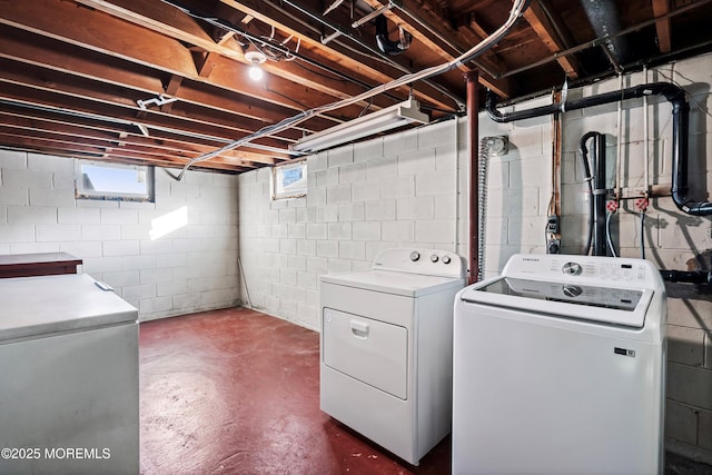 clothes washing area with washer and clothes dryer