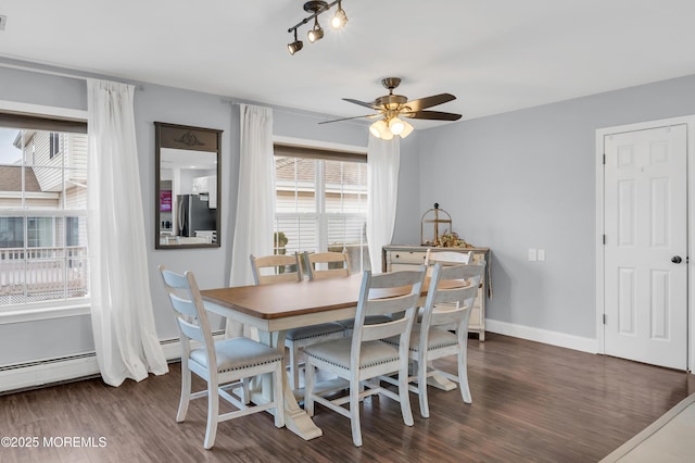 dining space featuring ceiling fan, a healthy amount of sunlight, and dark hardwood / wood-style flooring