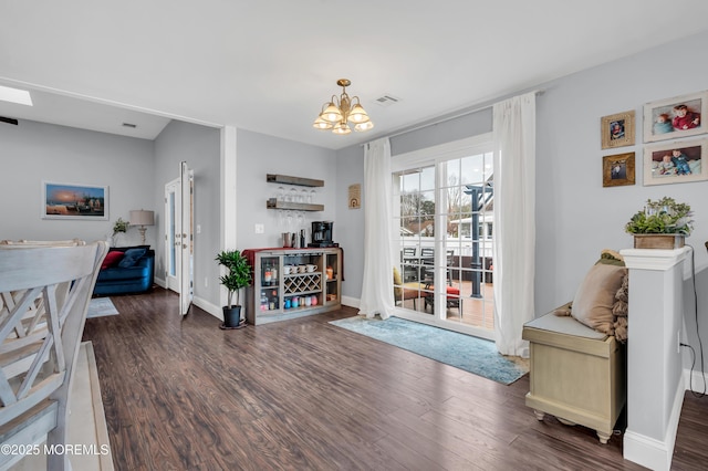 interior space with dark wood-type flooring and a chandelier